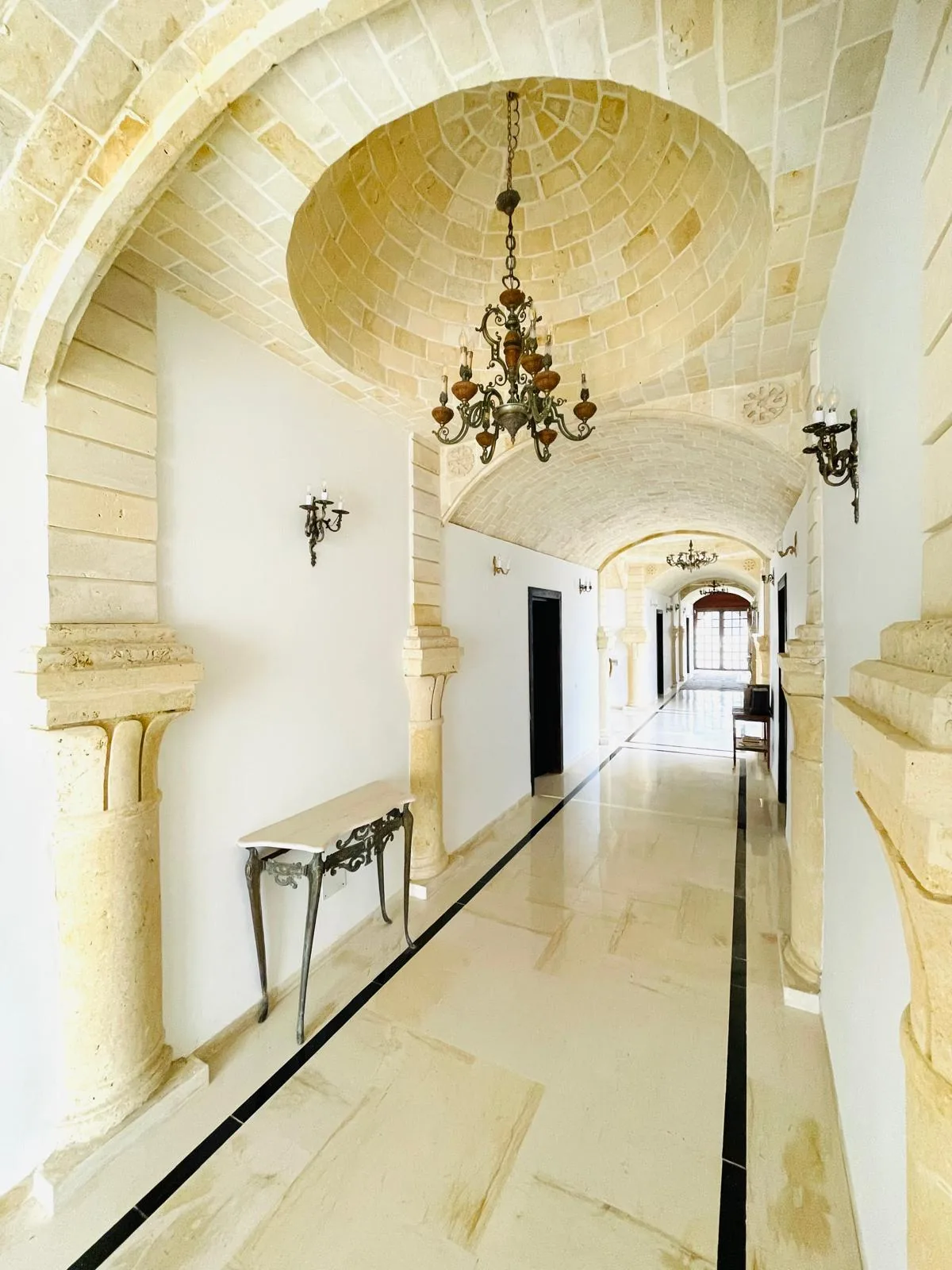 Vaulted stone corridor leading to the guest rooms at the Trinity Soul retreat property